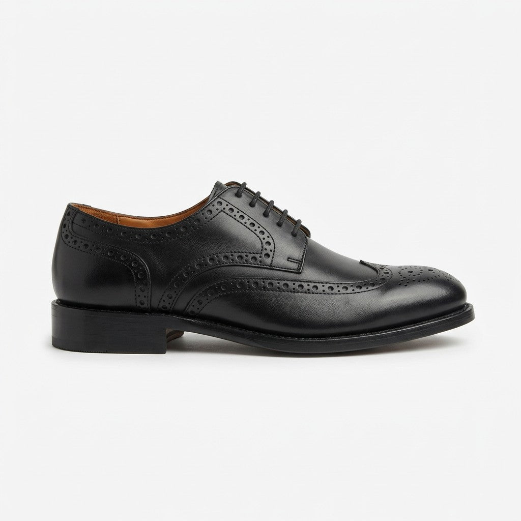 A single black leather ballet flat with a square toe and a small strap across the instep, shown in profile against a plain white background.
