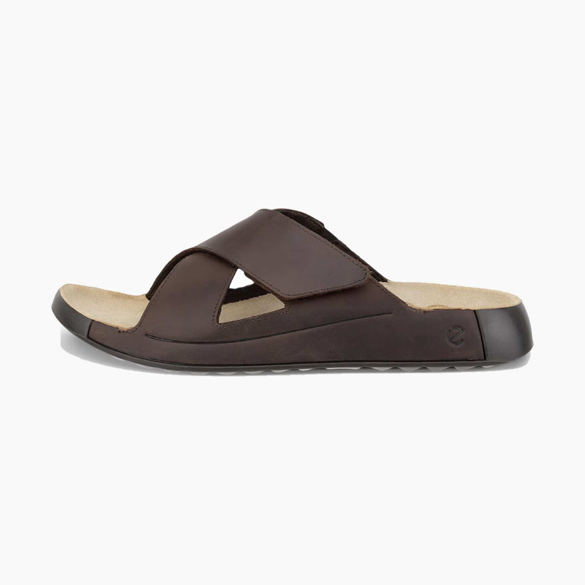 A dark brown leather slide sandal with a wide adjustable strap and a contoured footbed, shown from a side profile on a light gray background.