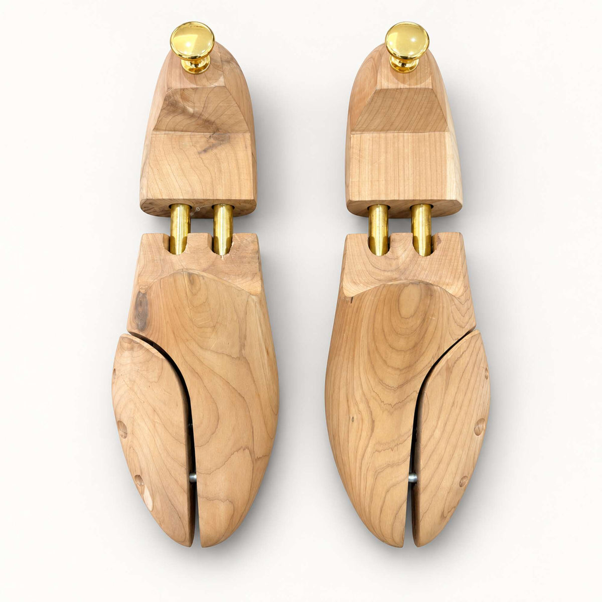 Fairdeal Shoes cedar wood shoe trees with gold-tone hardware for maintaining footwear shape and absorbing moisture.