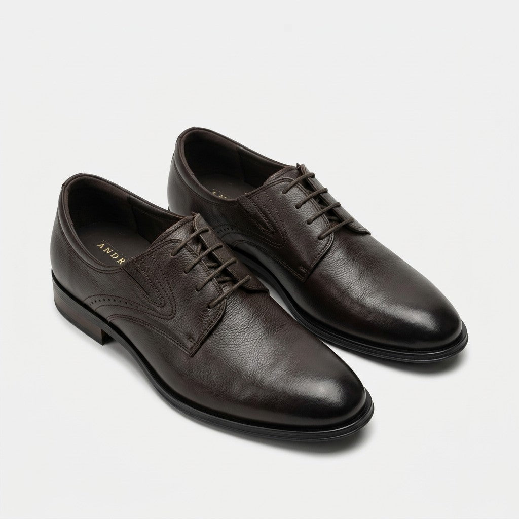 A pair of dark brown leather oxford shoes with laces, displayed on a clean light gray background.