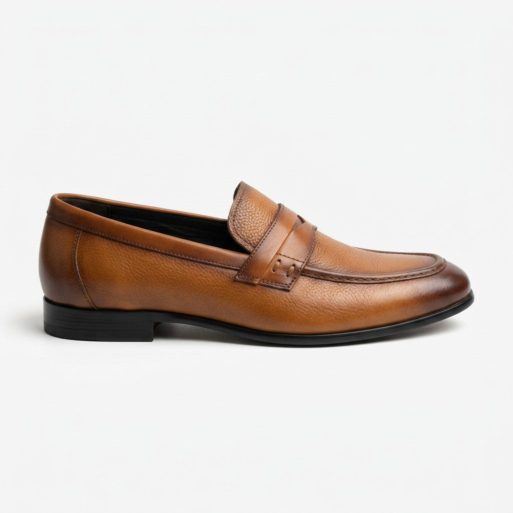 A single brown leather penny loafer shown in a side profile view against a clean white background.
