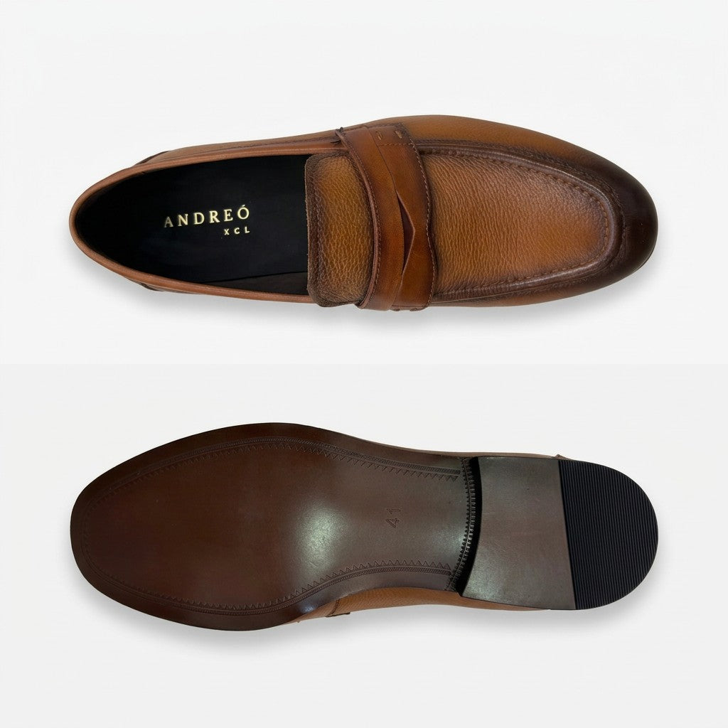A pair of men's penny loafers shown from the top and bottom views on a light gray background. The shoes are made of brown leather with a darker brown heel tab and a black rubber outsole.