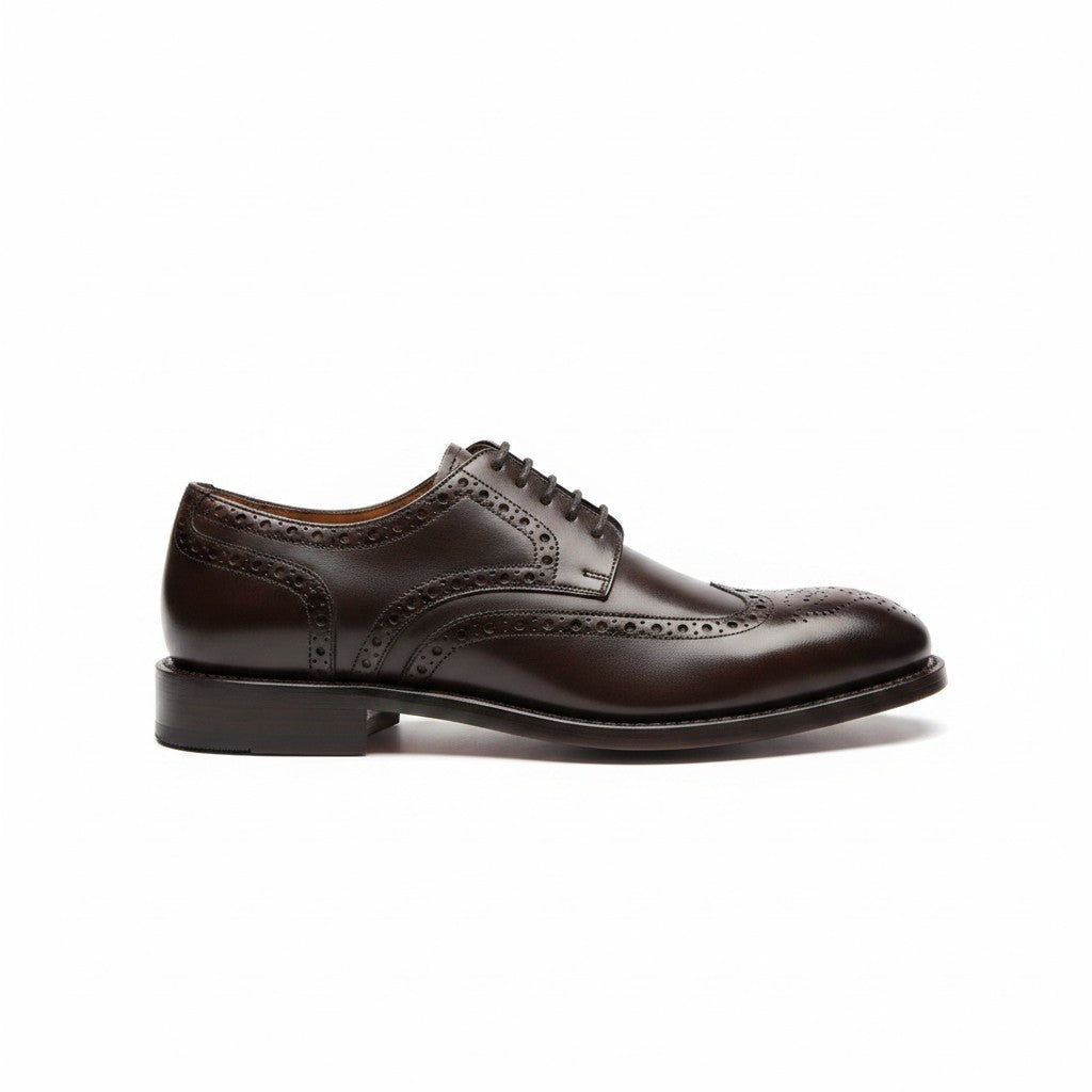 Black leather wingtip derby shoe on a white background