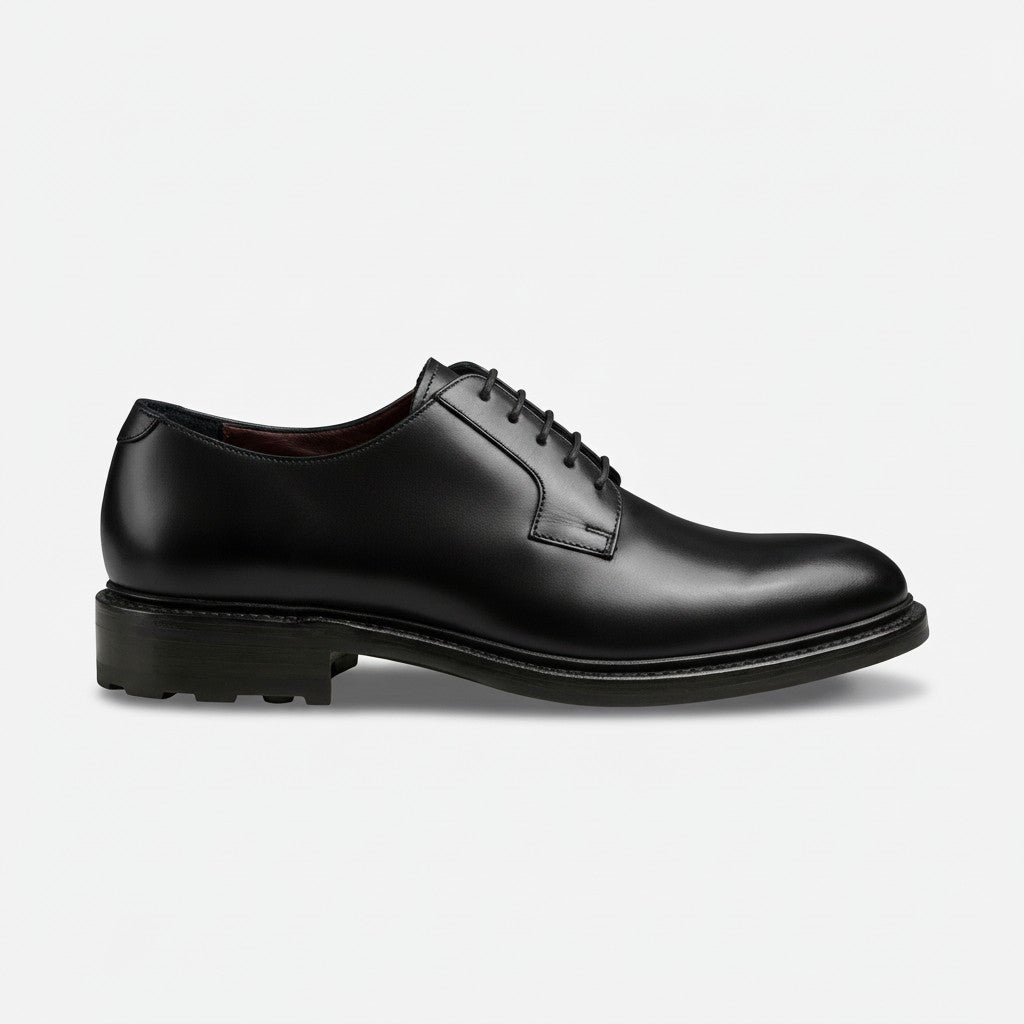 Black sneaker with unique sole design on a white background