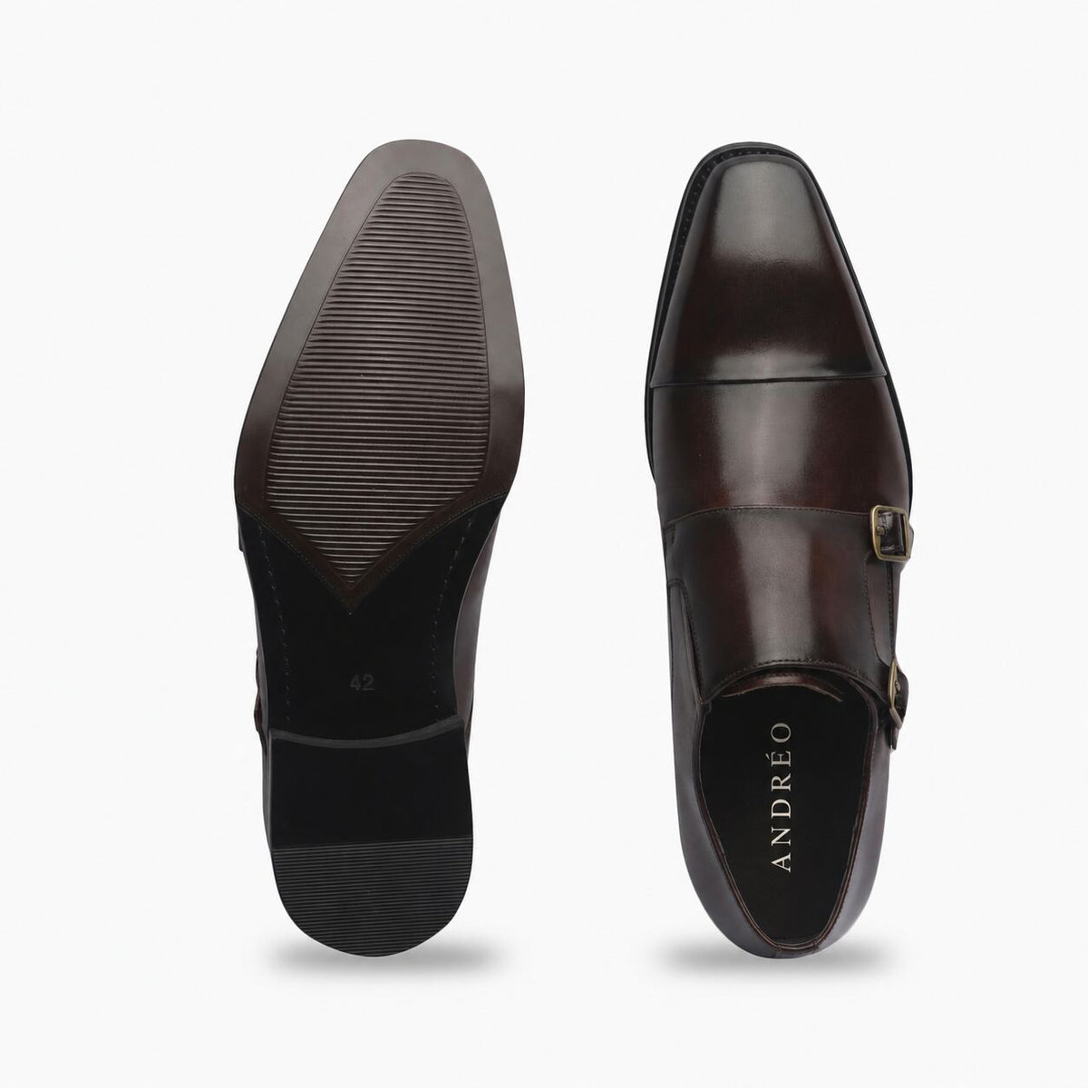 A pair of dark brown leather men's dress shoes shown from the top and sole views against a light gray background. The right shoe displays the polished cap-toe design, a double strap buckle closure, and the brand name 'GIORGIO' on the insole.