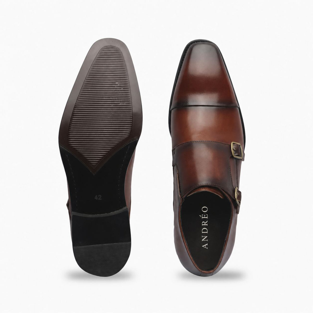 A pair of men's brown leather dress shoes shown from the top and sole views against a light gray background. The shoes feature a double strap design with brass-tone buckles and are branded with 'ANDRƒO' on the black insole.