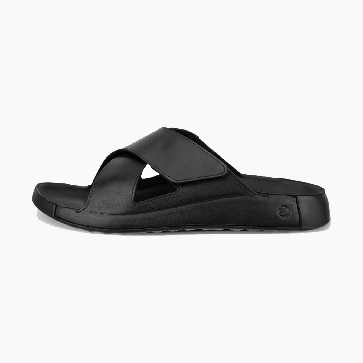 A single black slide sandal with a wide cutout strap and a thick platform sole, shown from a side profile on a light gray background.
