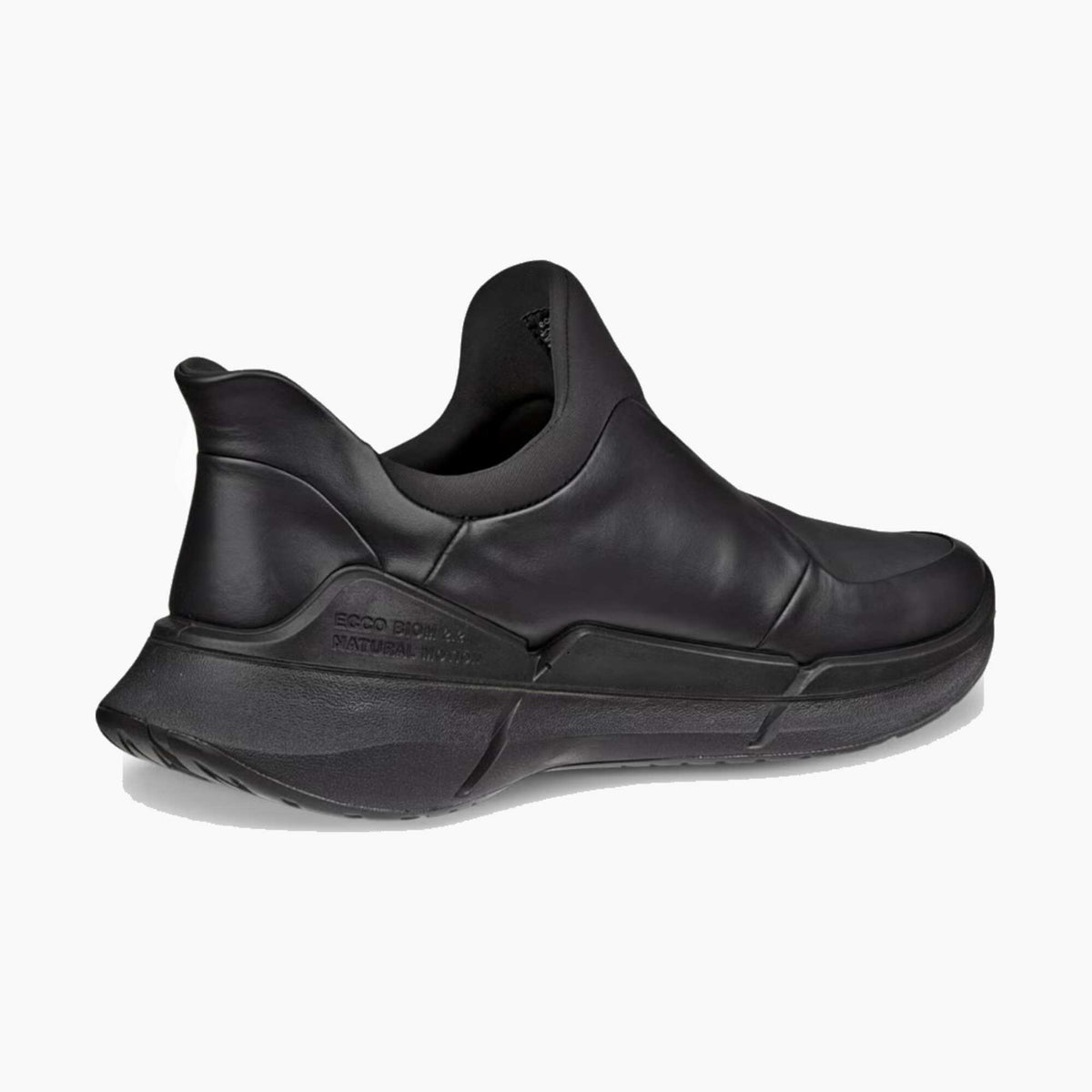 A black slip-on sneaker with a thick, sculpted platform sole, shown from a side profile view against a light gray background.
