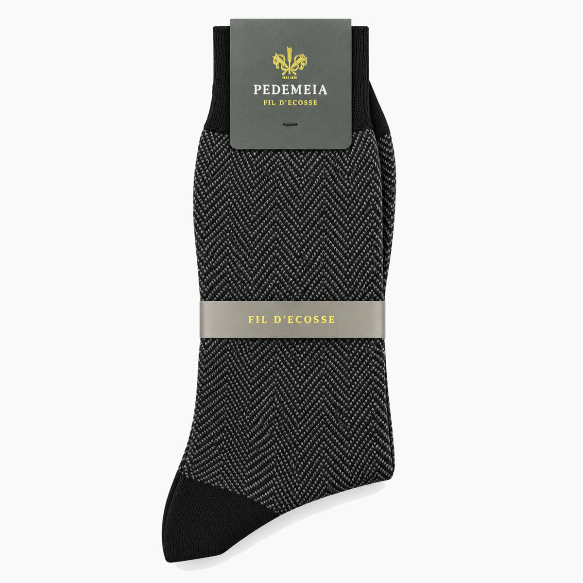A single men's dress sock from Pe demeia, featuring a black and gray herringbone pattern with solid black toe and heel sections, shown with its packaging on a light gray background.
